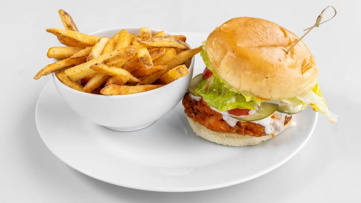 Crispy chicken burger with seasoned fries at Calgary Pub & Restaurant in Dover, Calgary, AB